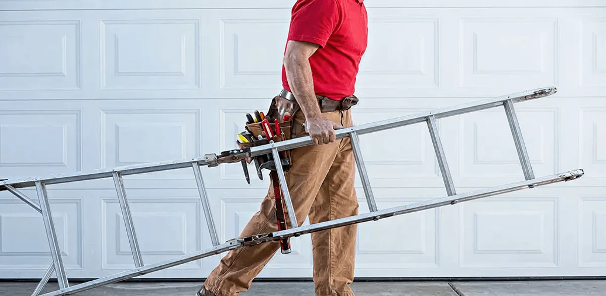 Garage door repair technician arriving with tools and ladder in Lowell, MA